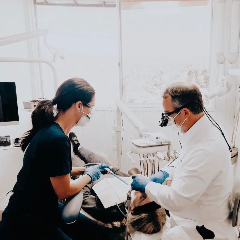 Dr. Frickman and his assistant treating a patient