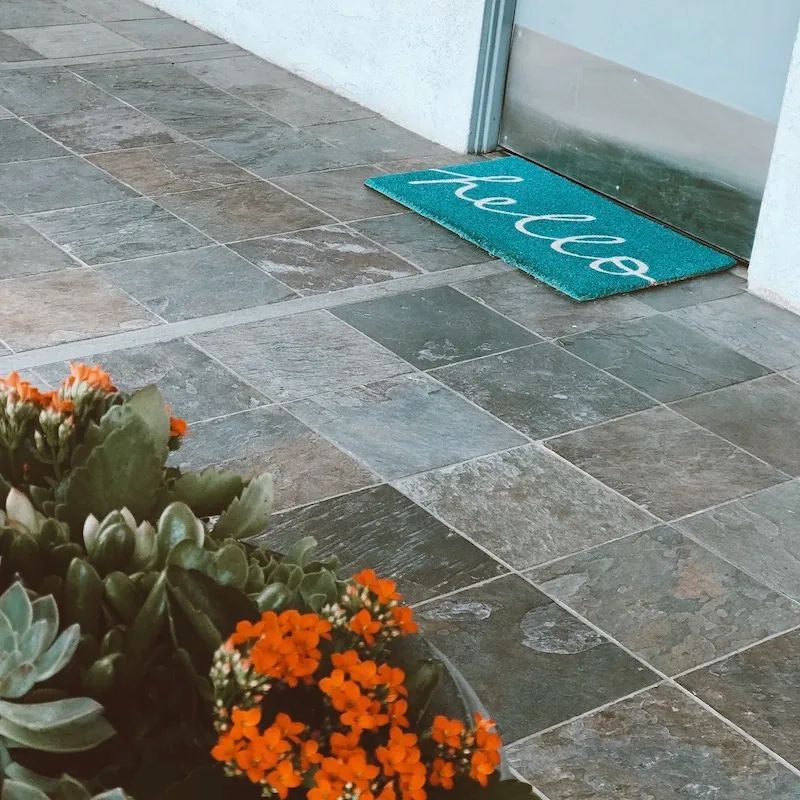 Office entrance with succulents and a 'hello' welcome mat